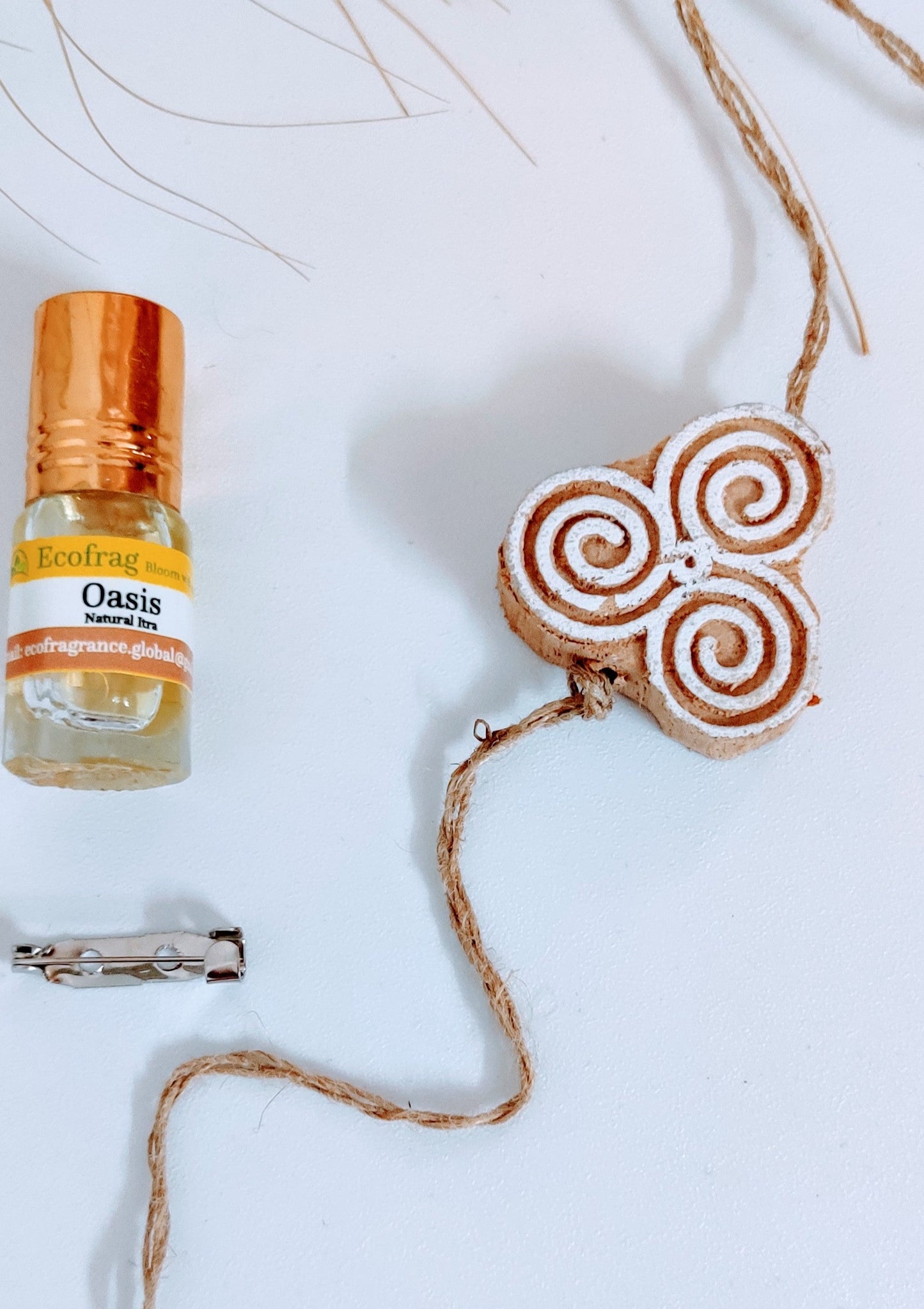 Three spirals wooden fragranted rakhi and brooch for bhai